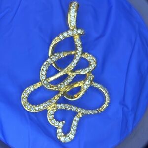 Gold tone vintage pendant with with rhinestones. Heart at the bottom.